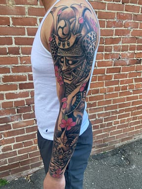 Black and Grey Neo-Traditional Sleeve - Samurai and Hannya Tattoo in Sacramento Neo-Traditional black and grey sleeve tattoo of a samurai and a hannya mask, crafted by a tattoo artist in Sacramento.